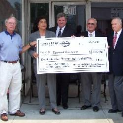 Richard Holder, Valeria Lee and John Merritt of the Golden LEAF Foundation present a check of $504,850 to Senator David Weinstein and Mayor Charles Kemp for the Fairmont-South Robeson Heritage Center.