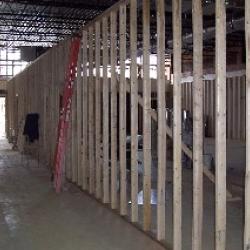 Studs are put in place for the interior walls of the community center. There will be a long hall separating two smaller classrooms from the main meeting room.