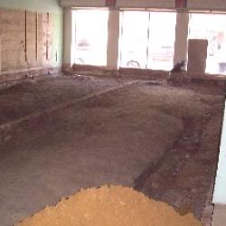 After the old flooring was removed, dirt was hauled in to level the floor.
