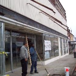 Employees from Ronald Nye Construction clean up after removing the old awning. (January 17, 2008)